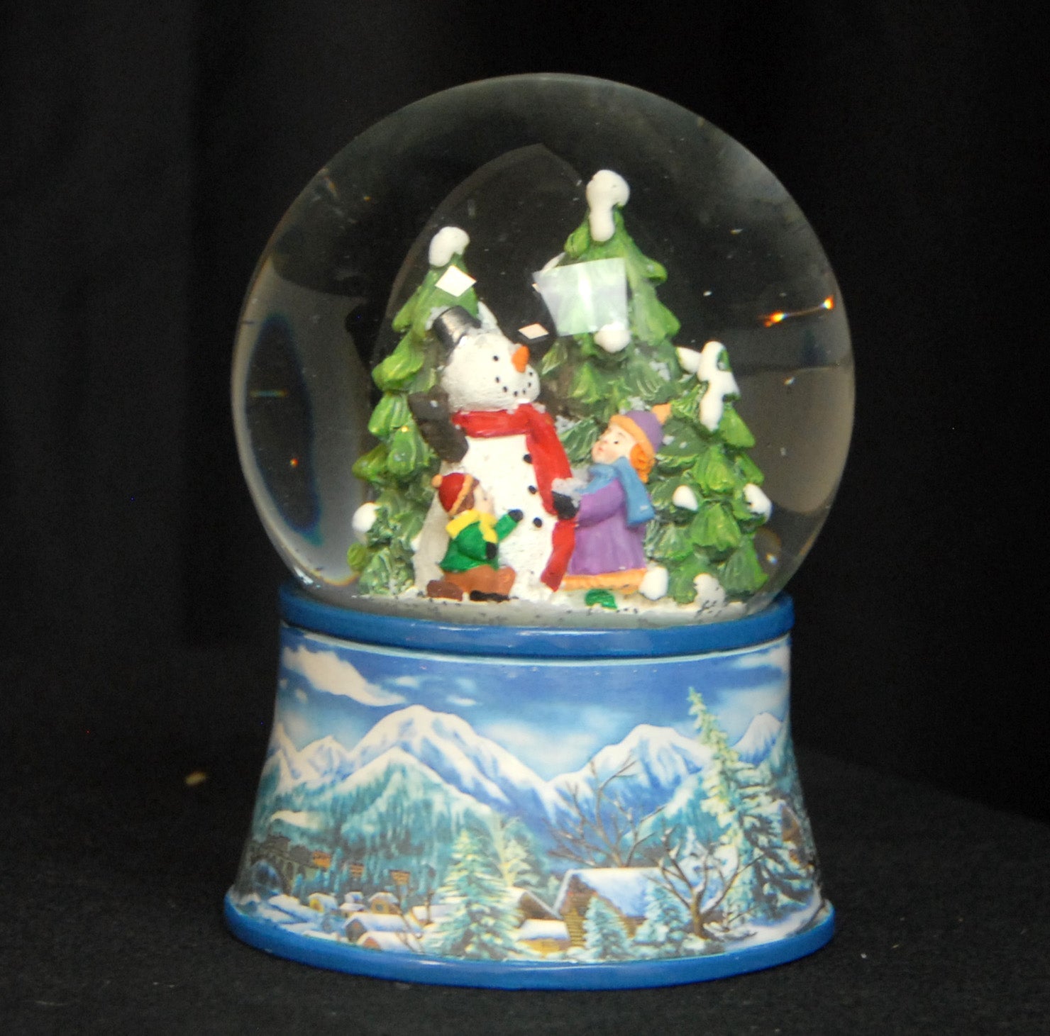 Nostalgische Schneekugel Kinder bauen Schneemann auf Sockel Winterlandschaft hellblau 100 mm Durchmesser mit Spieluhr - Schneekugelhaus