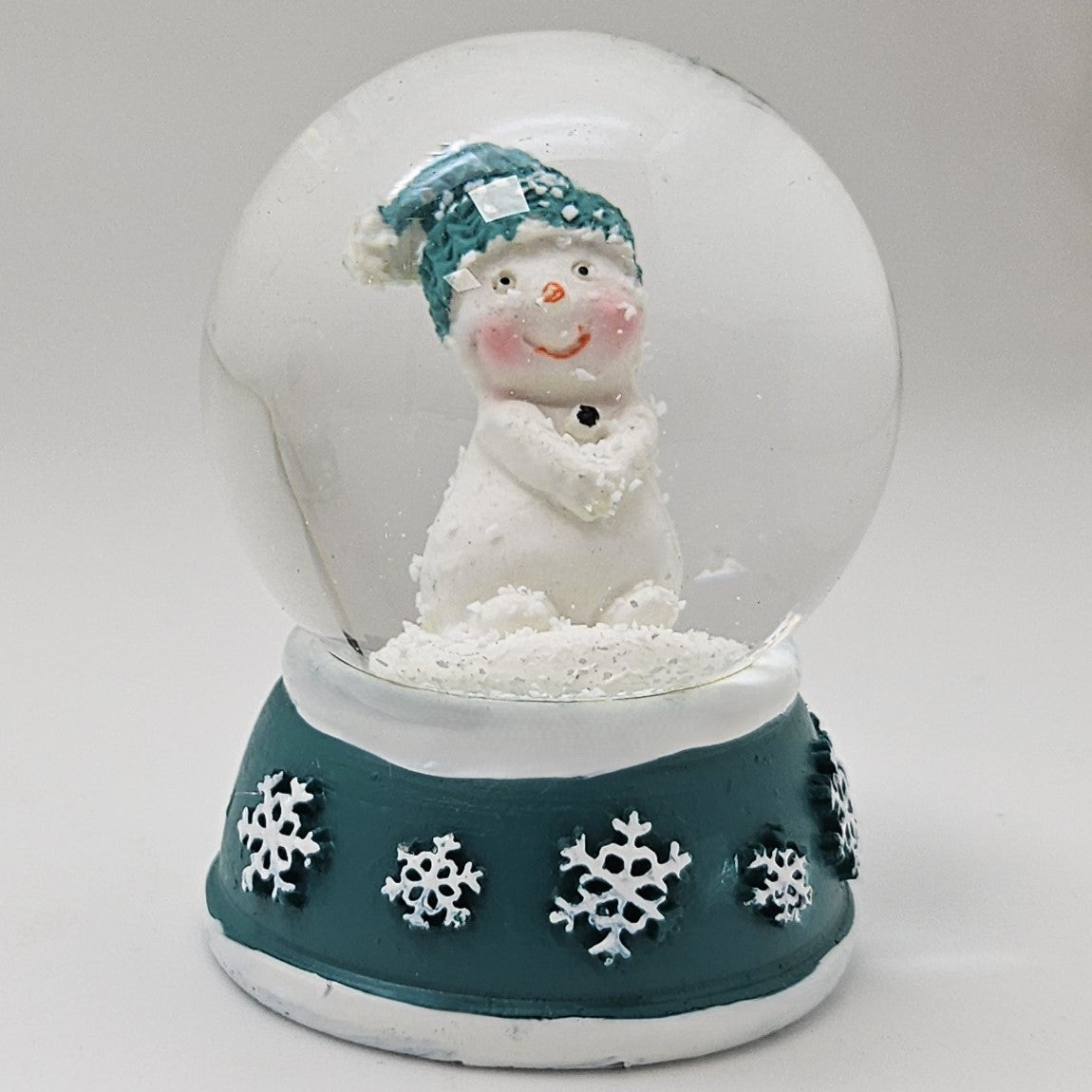Süße Mini - Schneekugel Schneemann Hände zusammen auf Sockel türkis weiße Schneeeflocke B: 45mm - Schneekugelhaus