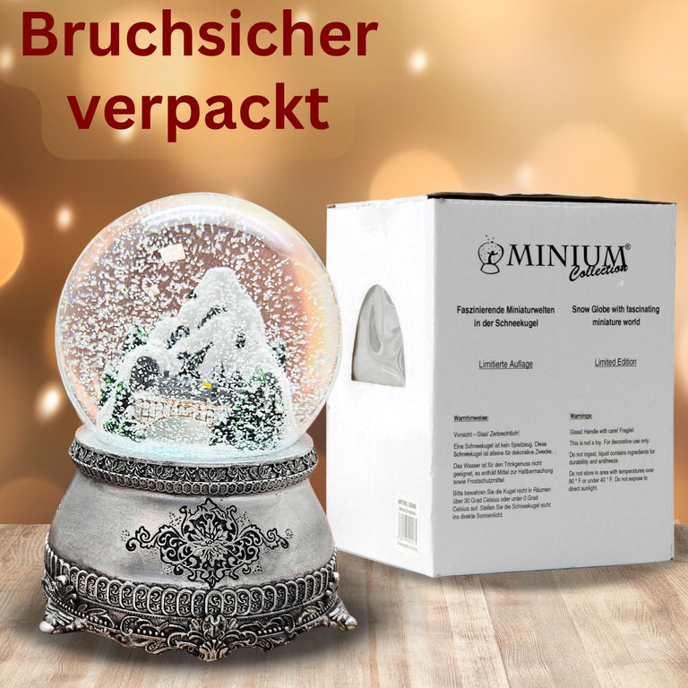 Nostalgische Schneekugel Berglandschaft mit Brücke auf Zinnsockel 100 mm Durchmesser mit Spieluhr - Schneekugelhaus