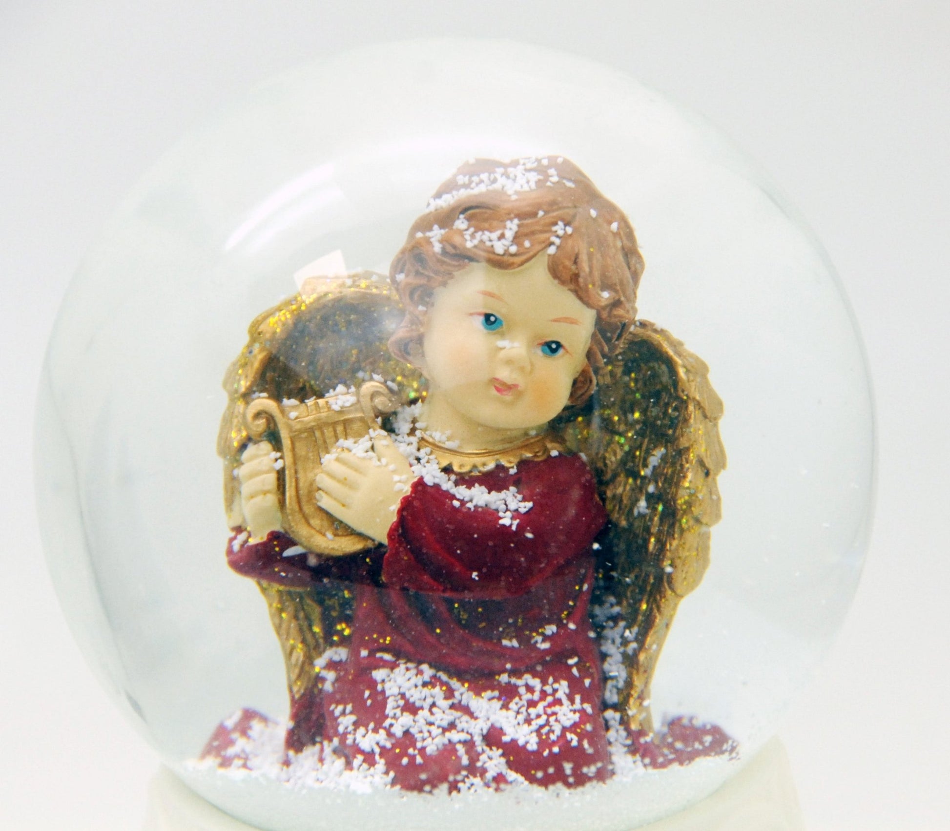 Edle Schneekugel Engel rot/gold mit Harfe auf weißem Porzellansockel 100 mm Durchmesser mit Spieluhr - Schneekugelhaus
