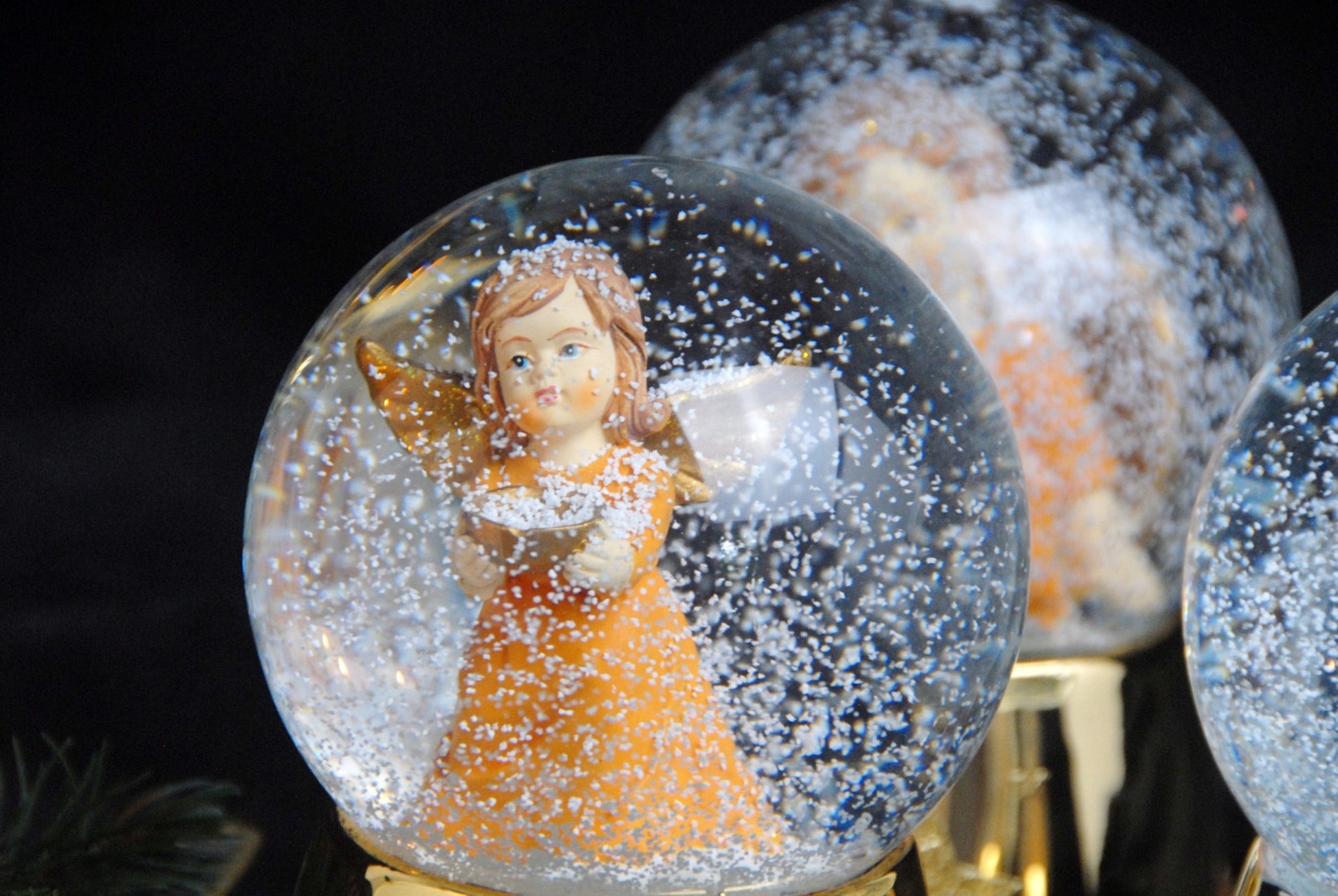 Schneekugel Engel orange mit Schale gold auf Sockel gold mit Sternen mit Spieluhr - Schneekugelhaus