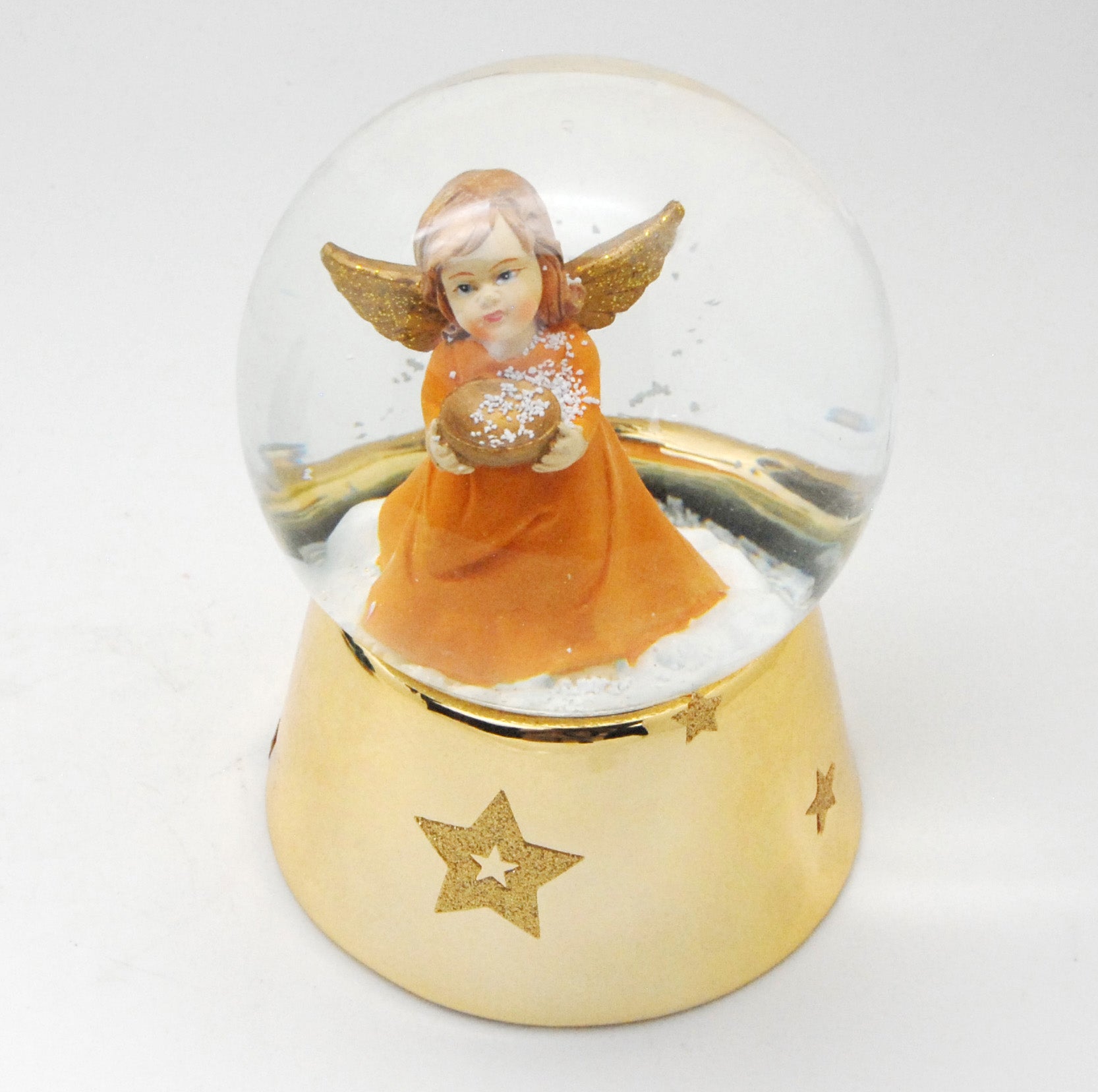 Schneekugel Engel orange mit Schale gold auf Sockel gold mit Sternen mit Spieluhr - Schneekugelhaus