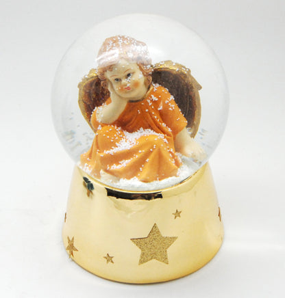 Schneekugel Engel orange sitzt auf Sockel gold mit Sternen mit Spieluhr - Schneekugelhaus