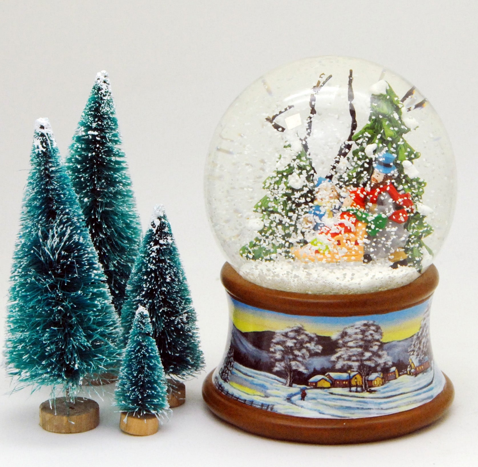 Schneekugel Familie mit Schlitten im Winterwald auf Sockel Winterlandschaft braun mit Spieluhr - Schneekugelhaus