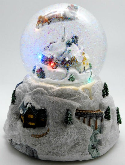 Schneekugel Weihnacht Fliegender Santa mit Drehspieluhr Snowmotion und LED - Schneekugelhaus
